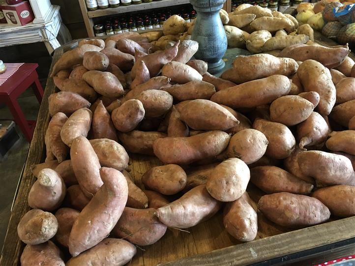 Sweet potatoes in a wooden basket on a display