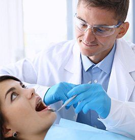 Periodontal Disease — Dentist Examining Patient's Teeth in Kalamazoo, MI Periodontal Disease — Dentist Examining Patient's Teeth in Kalamazoo, MI