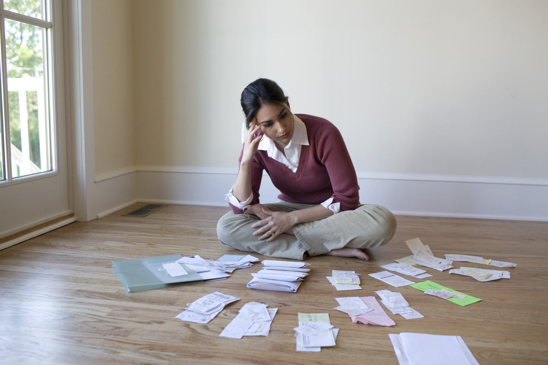 Tax Debt — Woman Looking at Bills on the Floor in Aiken, SC Tax Debt — Woman Looking at Bills on the Floor in Aiken, SC