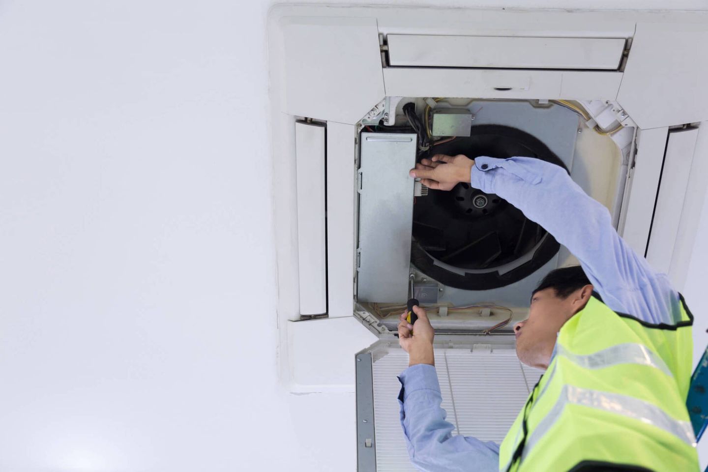 Air conditioning engineer checking the ventilation system