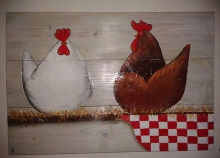 Twee beschilderde kippen op hout, een witte en een bruine, naast een rood-wit geblokt kleed.