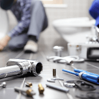 Plumbing Contractor — Plumber fixing a broken pipe In Chicago, IL Plumbing Contractor — Plumber fixing a broken pipe In Chicago, IL