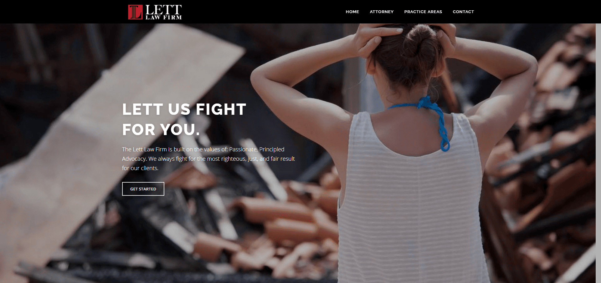 A woman is standing in front of a pile of rubble with her hands on her head.