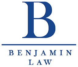 The logo for benjamin law is a blue letter b on a white background.