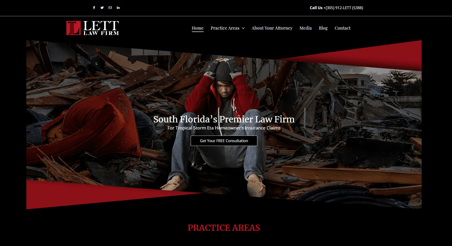 A man in a red jacket is sitting in a pile of rubble.