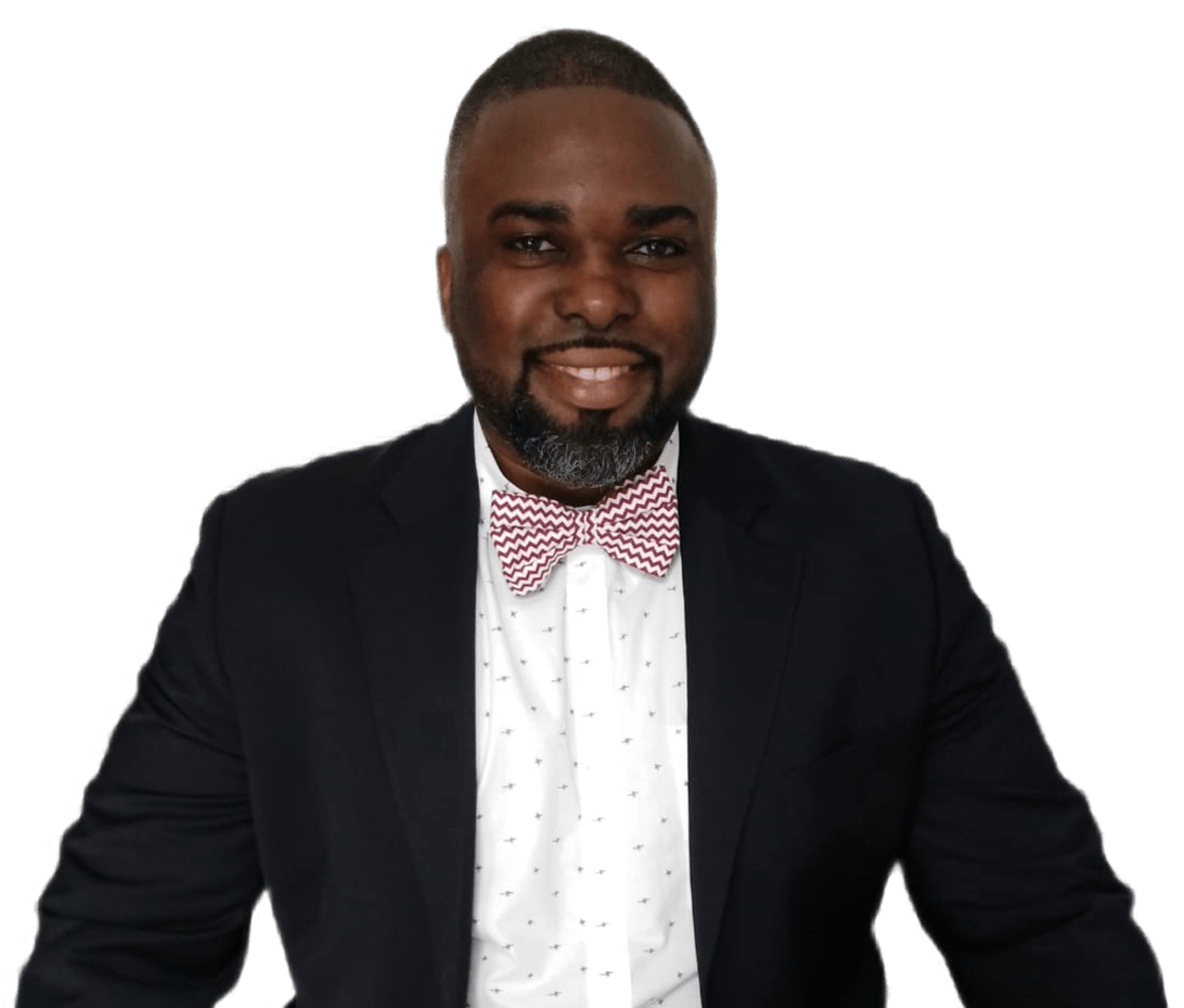 A man in a suit and bow tie is smiling for the camera