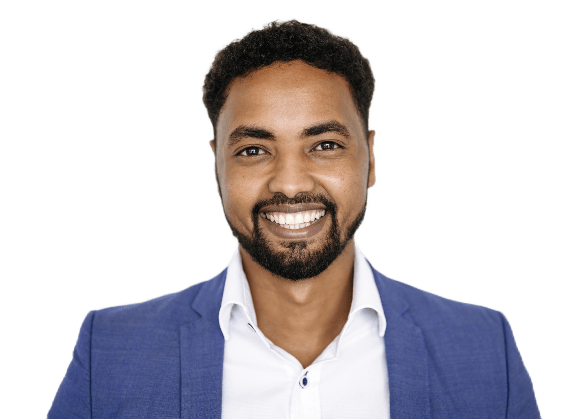 A man with a beard is wearing a blue jacket and smiling.