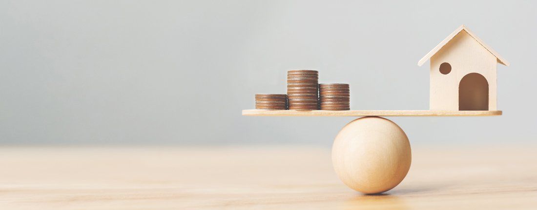 Wooden Home and Money Coins Stack on Wood Scale — Fort Smith, AR — ASAP Insurance Wooden Home and Money Coins Stack on Wood Scale — Fort Smith, AR — ASAP Insurance