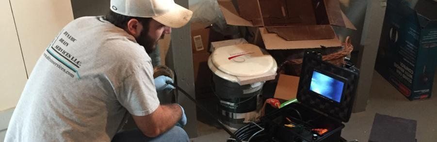 Man Working Indoor House Sewer — Port Huron, MI — Dynamic Drain Services
