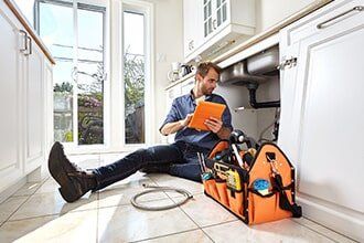 Plumber Checking a Sink — Plumbing Contractor in Sacramento, CA Plumber Checking a Sink — Plumbing Contractor in Sacramento, CA