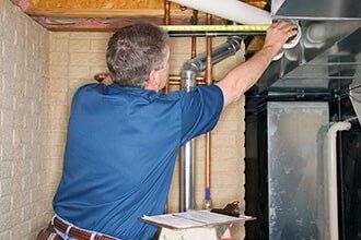 Plumber Inspecting a Pipe — Plumbing Contractor in Sacramento, CA Plumber Inspecting a Pipe — Plumbing Contractor in Sacramento, CA