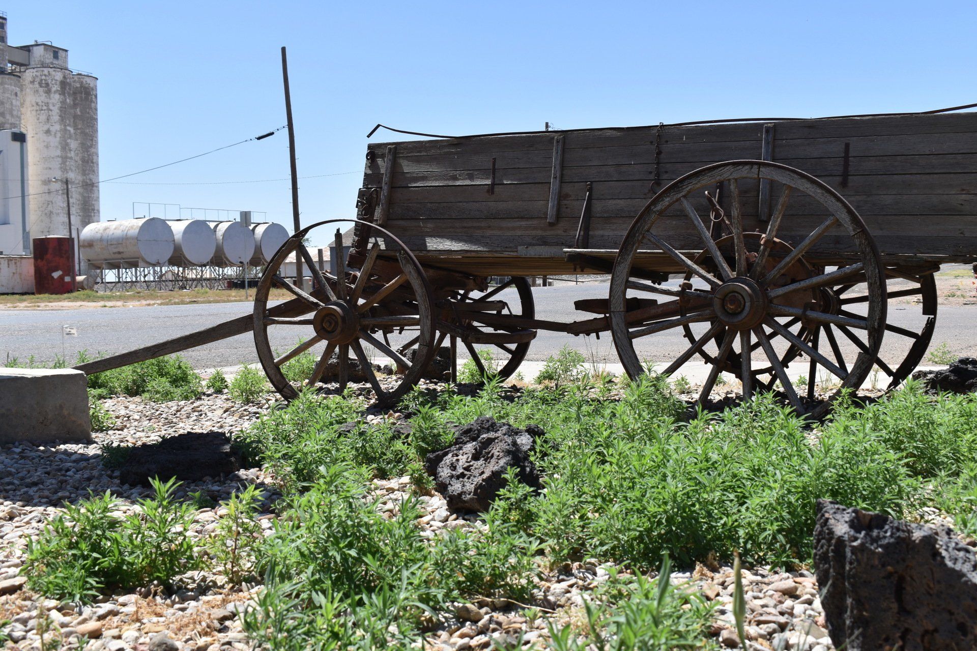 An old wooden wagon is parked on the side of the road.