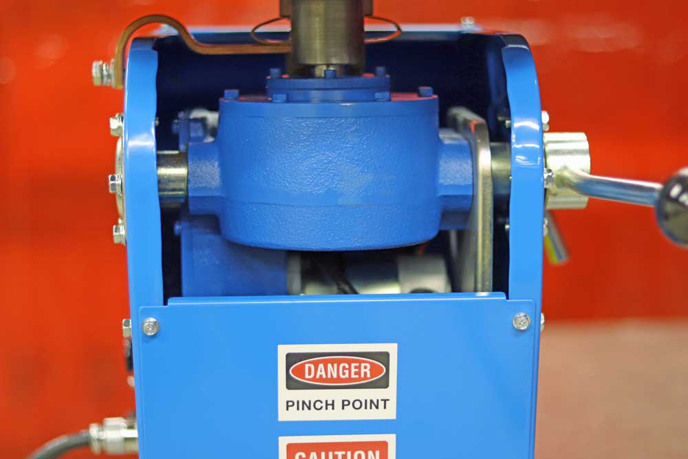 A blue machine with a danger pinch point sign on it