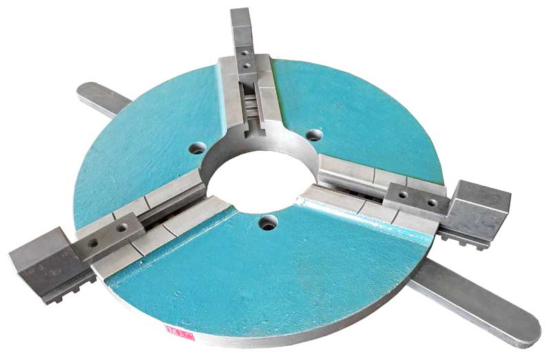 A close up of a machine chuck on a white background.
