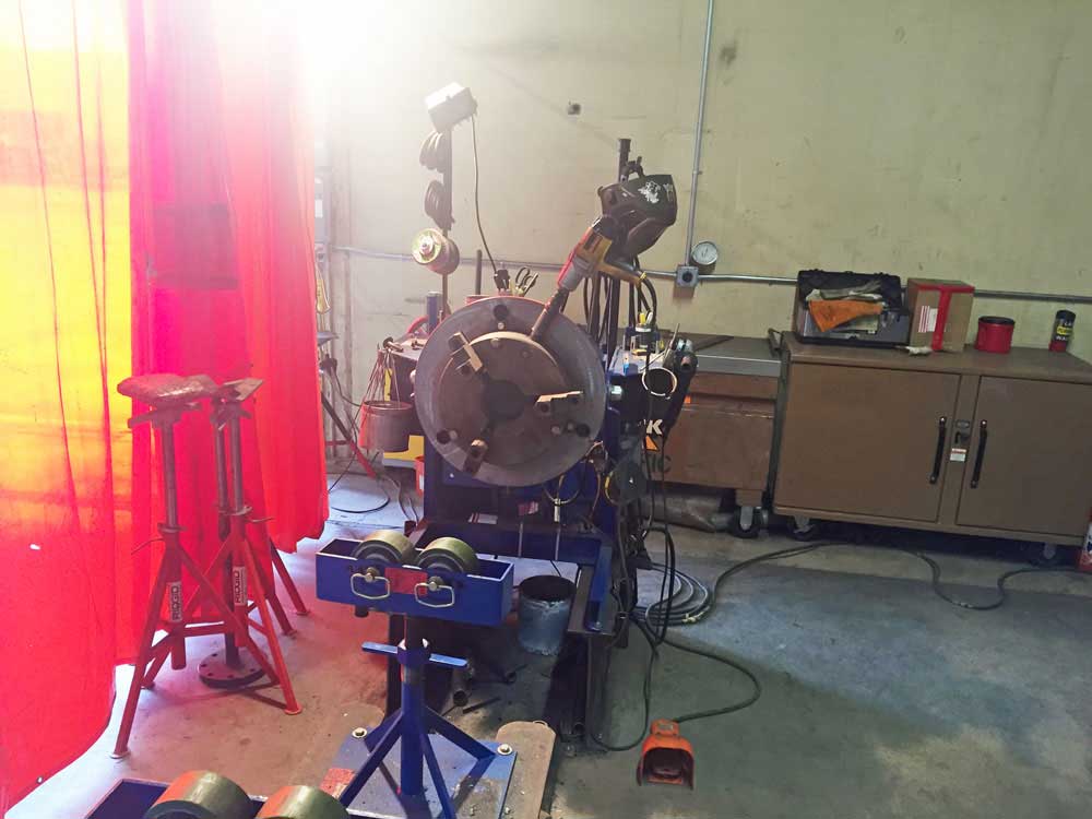 A machine is sitting in a room with a red curtain behind it
