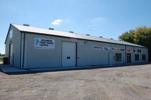 A large building with a sign that says delmont pump parts united