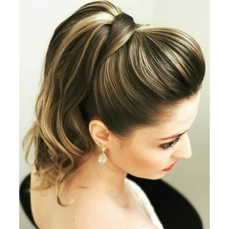 A woman is wearing a ponytail and earrings.