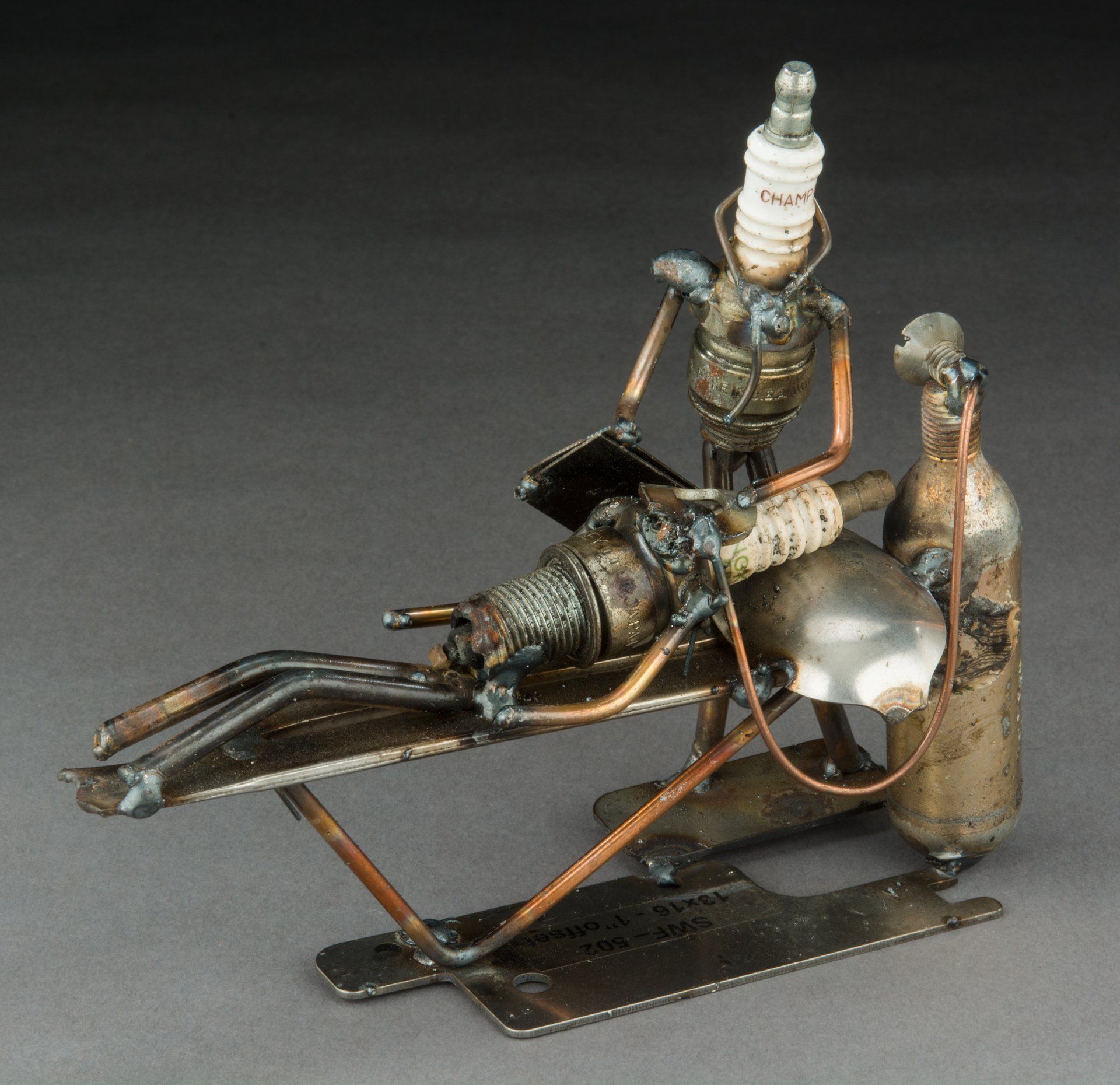 Sparkplug Sculpture of Anesthesiologist working with patient lying on bed 