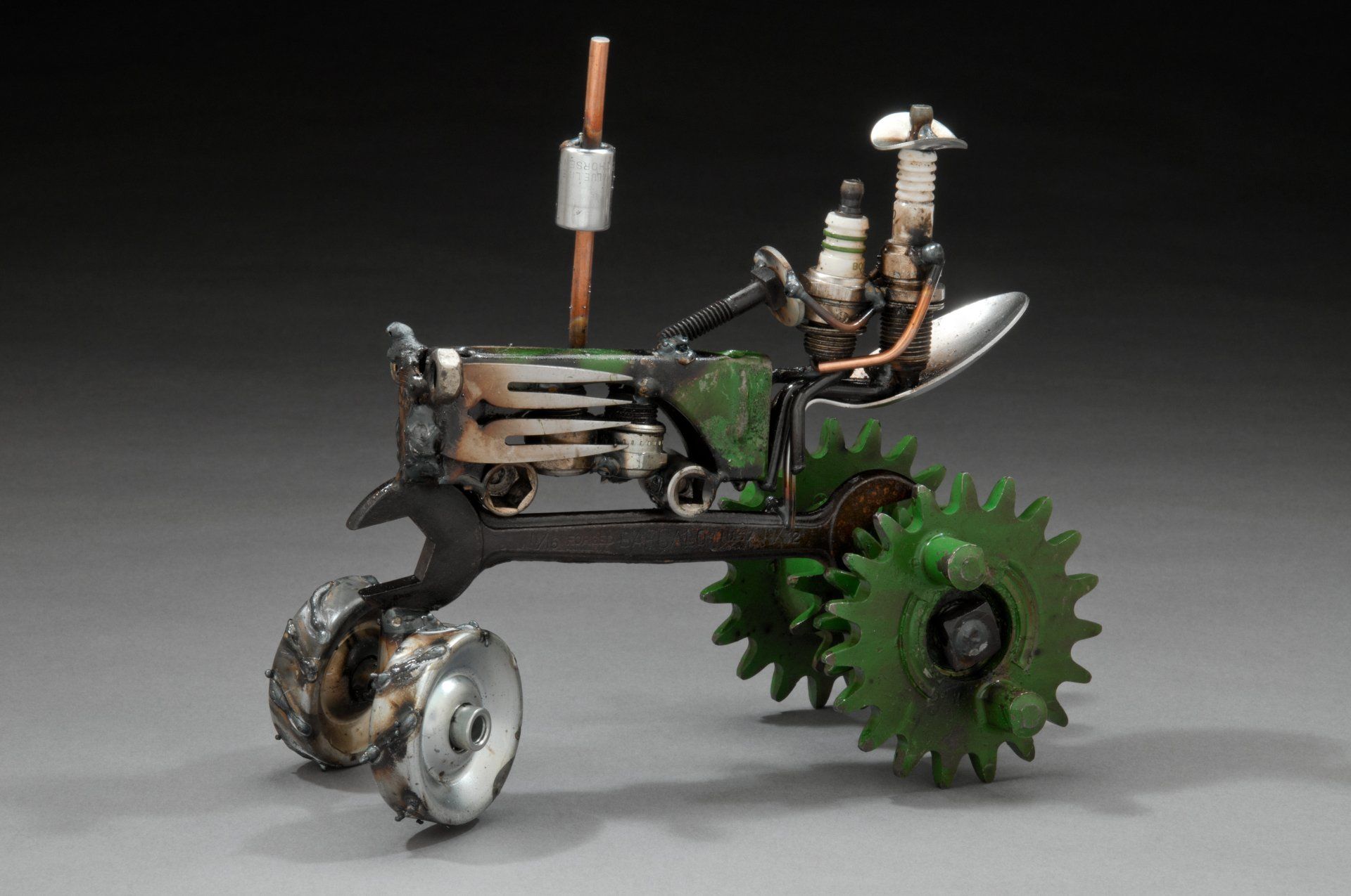 Sparkplug Sculpture of Adult and Child Figurines on John Deere Tractor