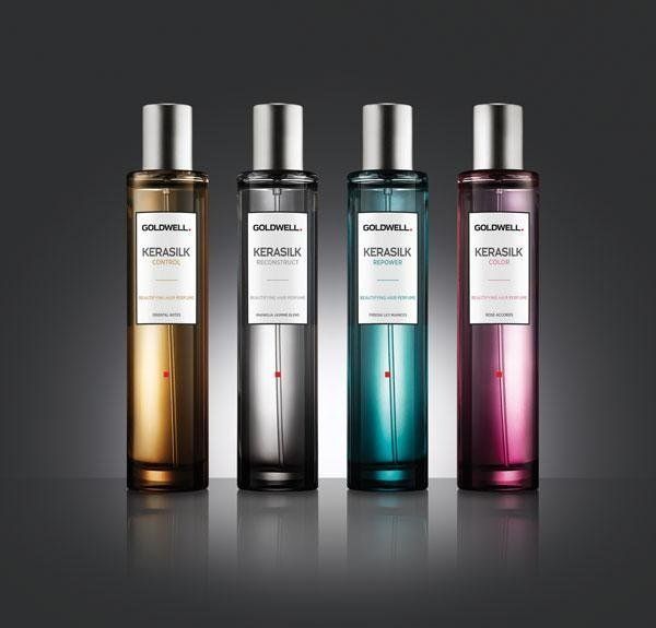 Quattro flaconi di profumo Goldwell Kerasilk in diversi colori su uno sfondo scuro.