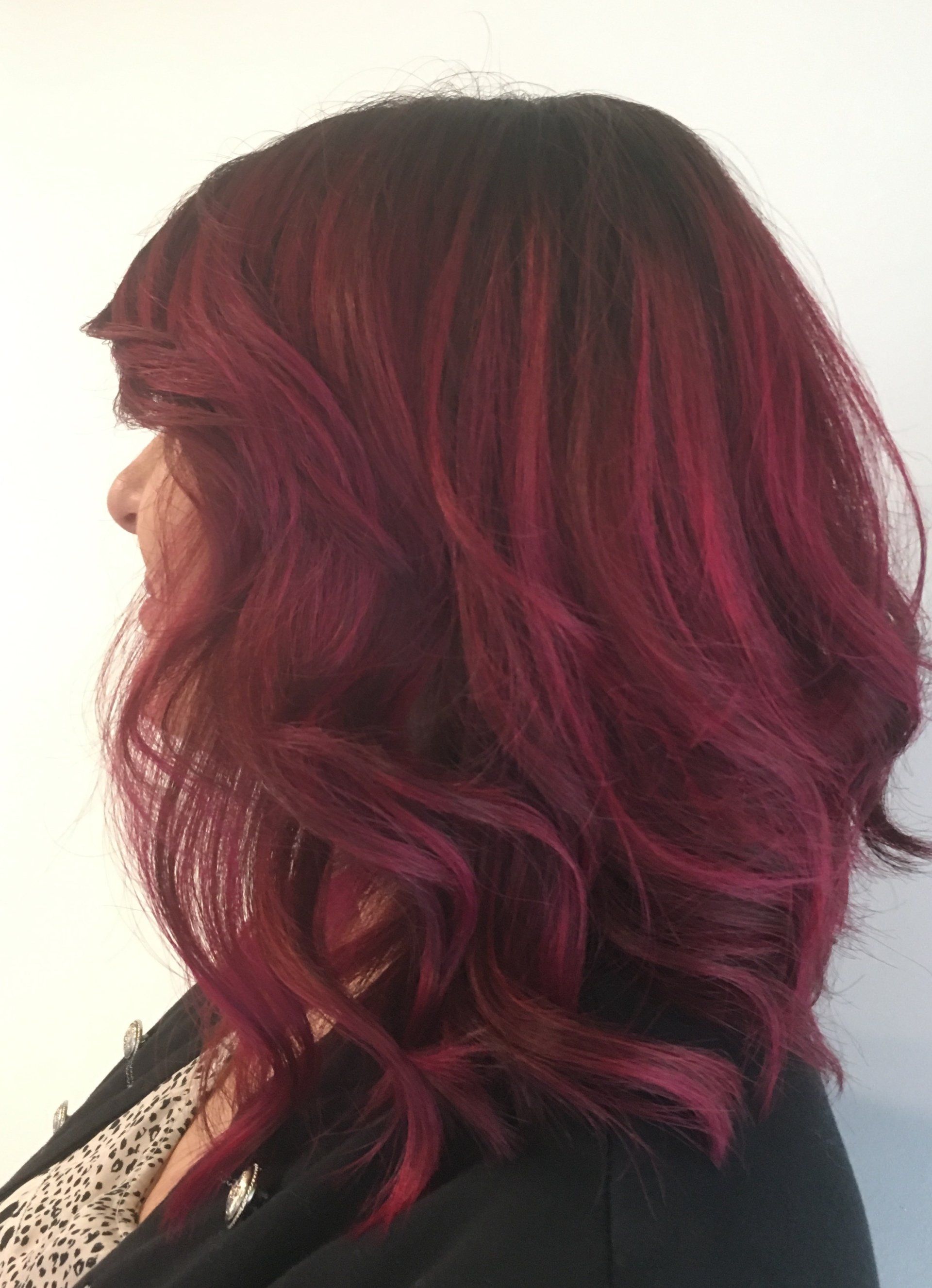 Donna con capelli color borgogna, acconciati in un caschetto ondulato.