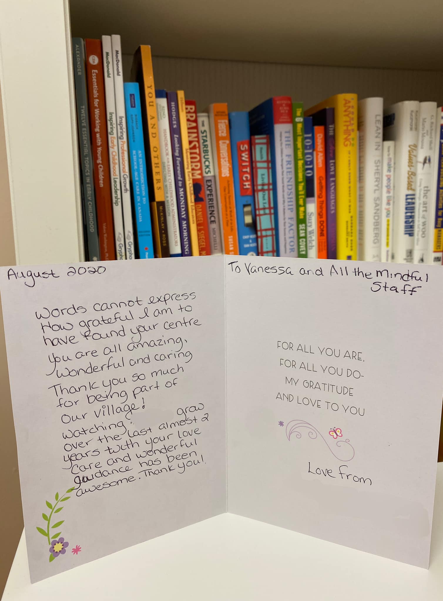 A book shelf with a card that says