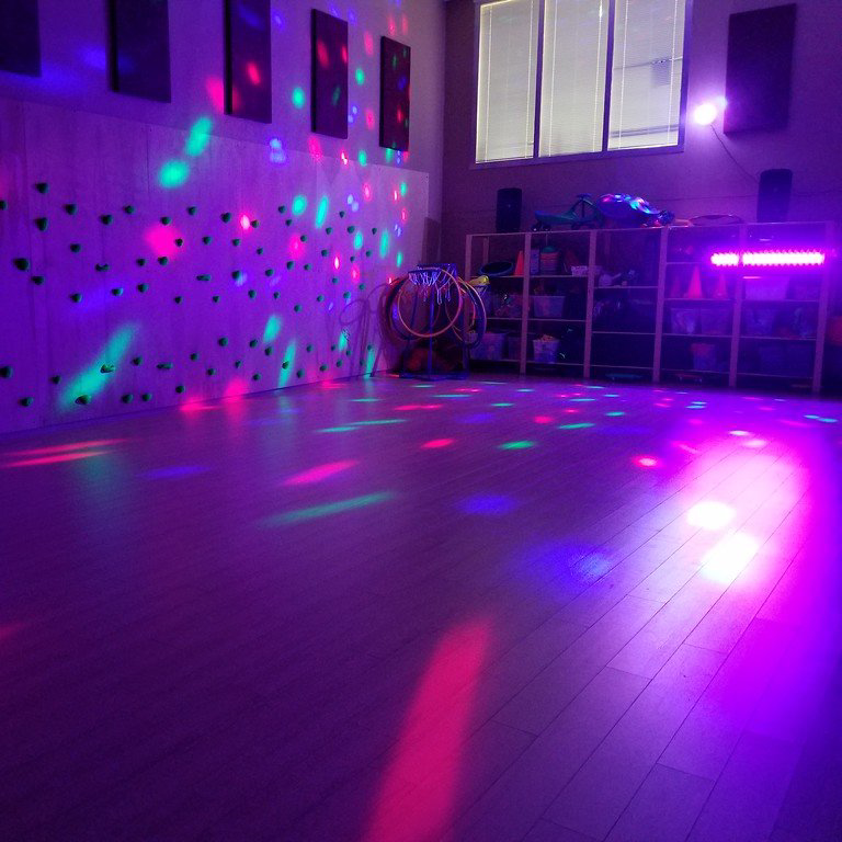 A room with a lot of lights on the floor and walls.