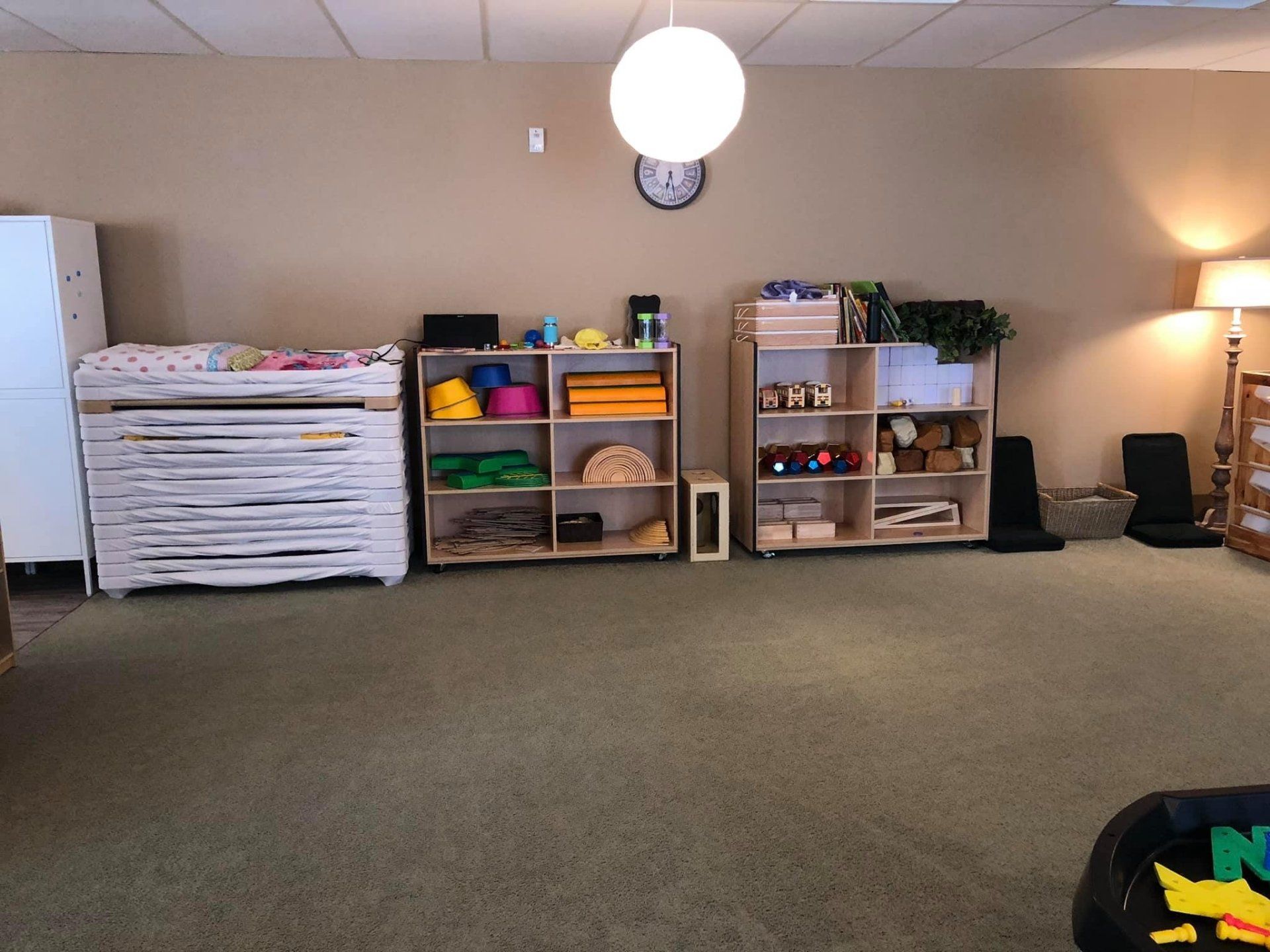 A room with a lot of shelves and a clock on the wall