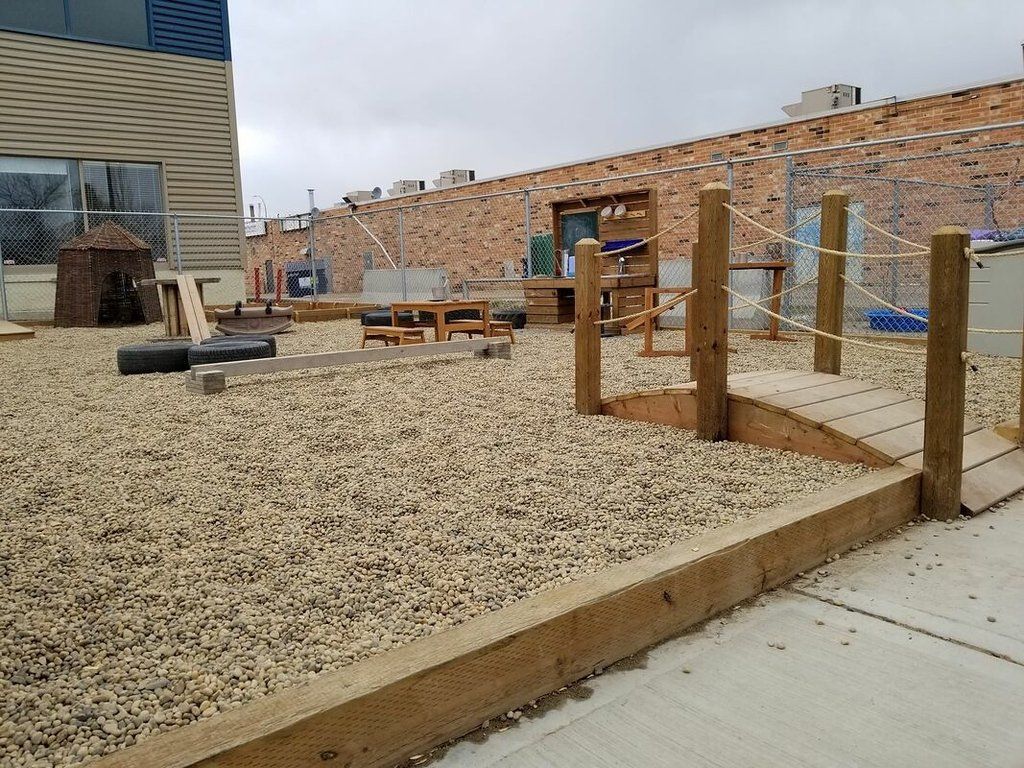 A brick building with a playground in front of it