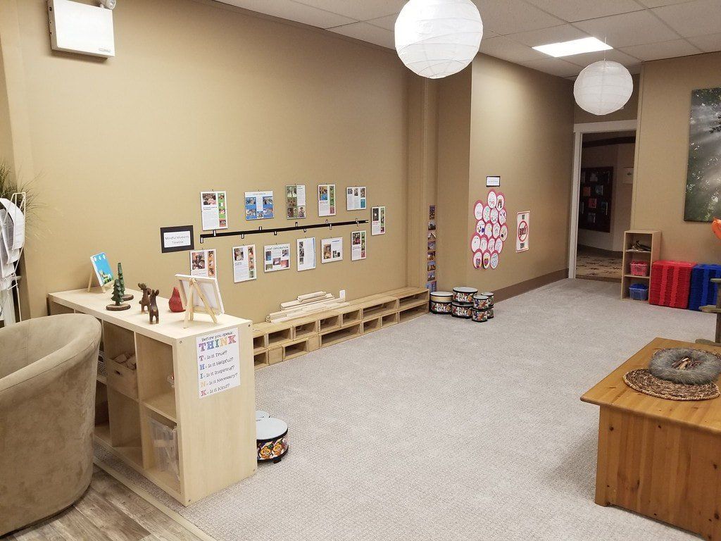 A large room with a lot of furniture and pictures on the wall.