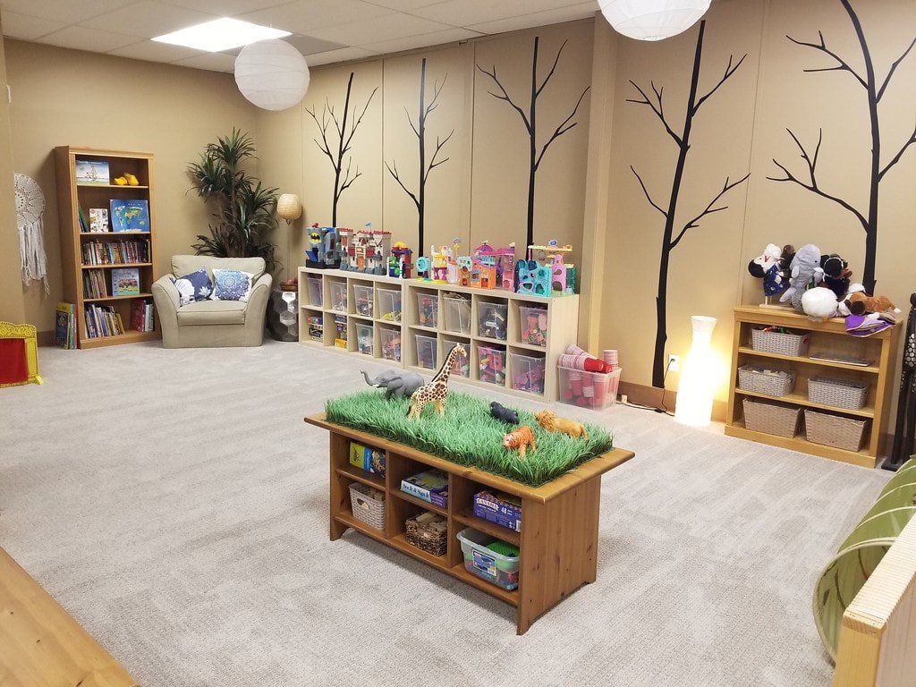 There is a table with animals on it in the middle of the room.