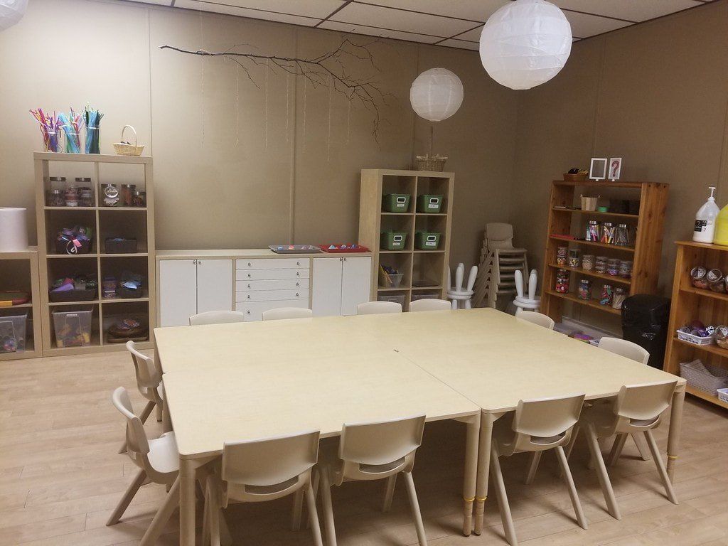 A room with a long table and chairs in it