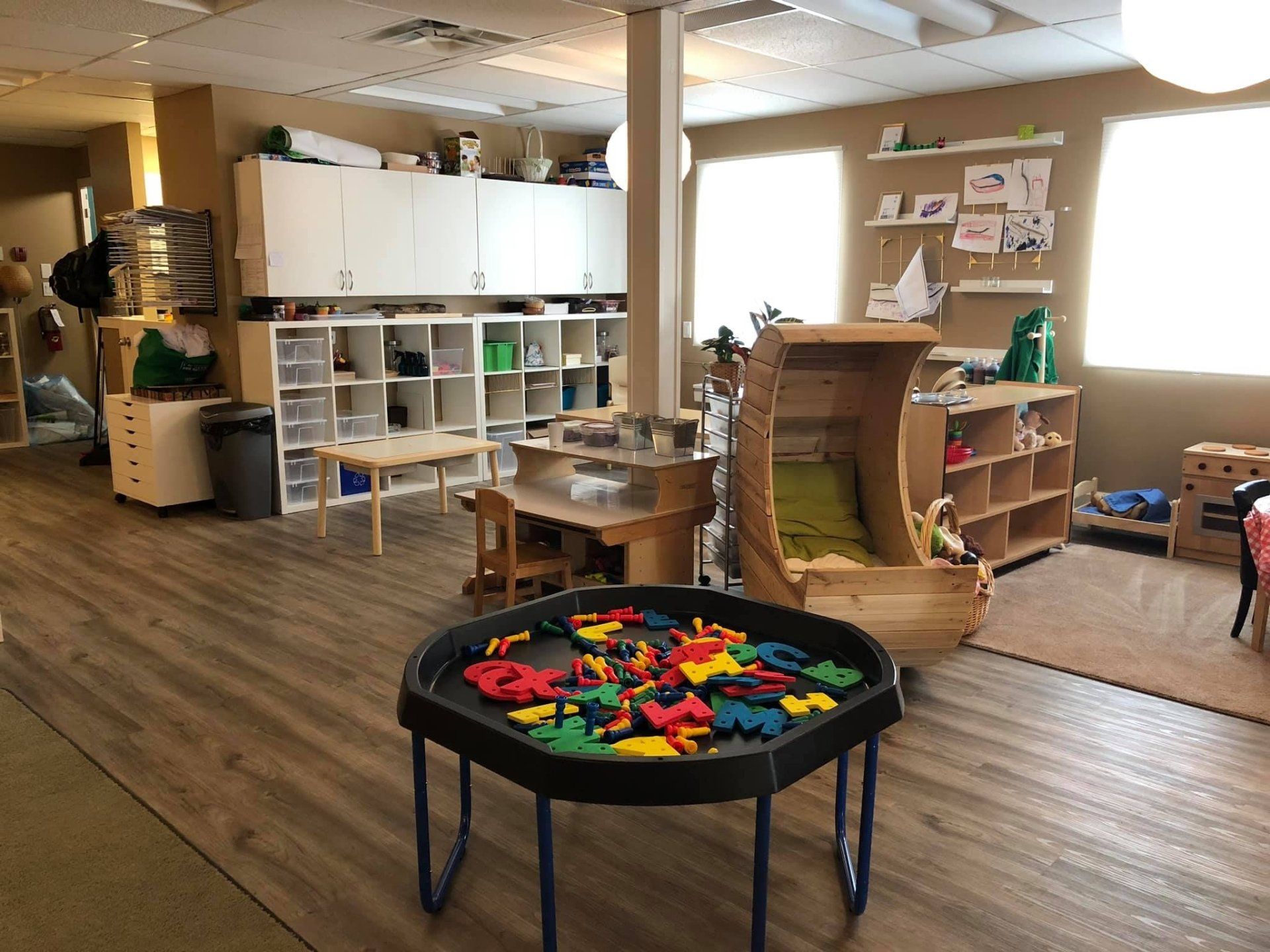 There is a table with letters on it in the middle of the room.
