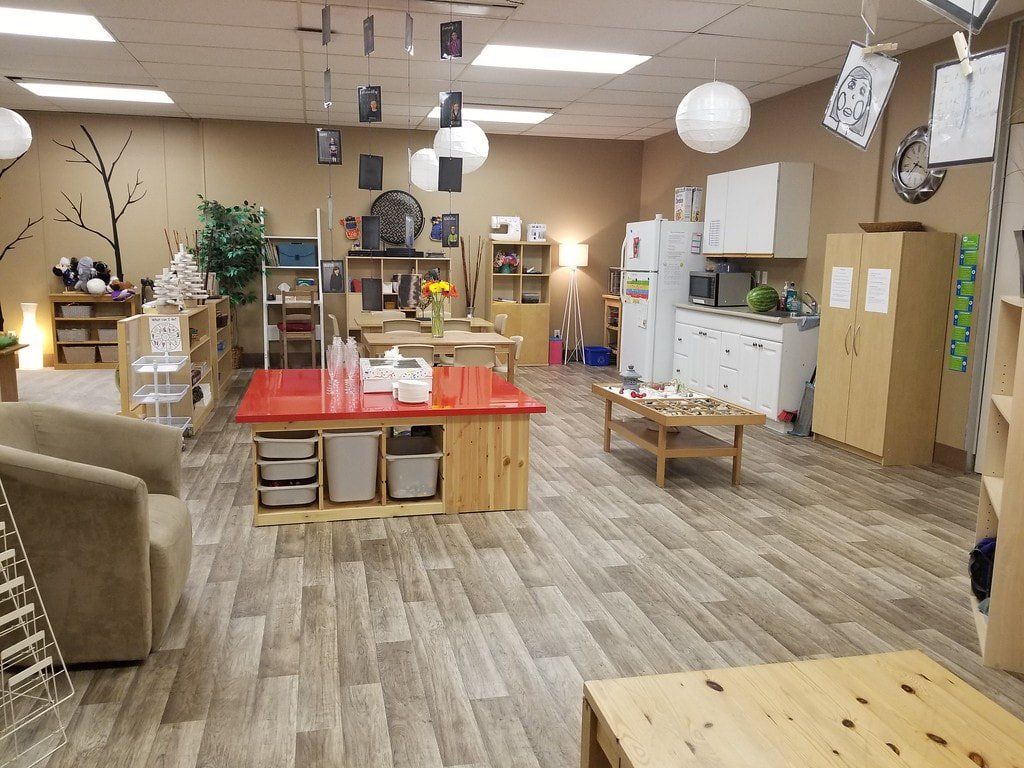 A large room with a lot of furniture and a red table.