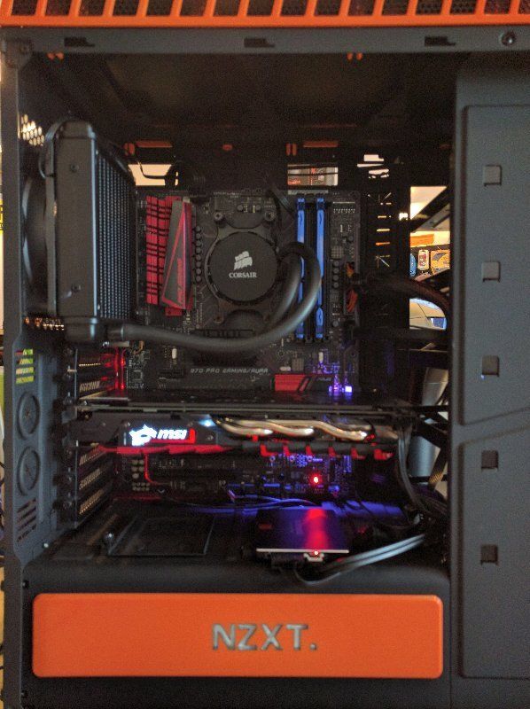 A black and orange computer case with the word nzxt on it
