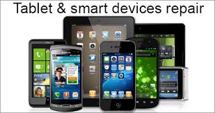 A group of cell phones and tablets are sitting next to each other.