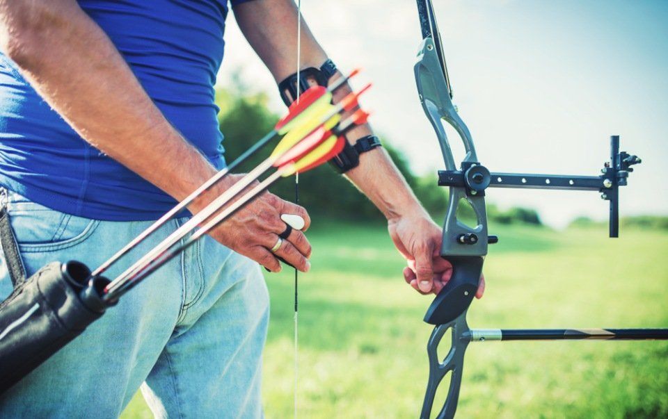 man practicing archery