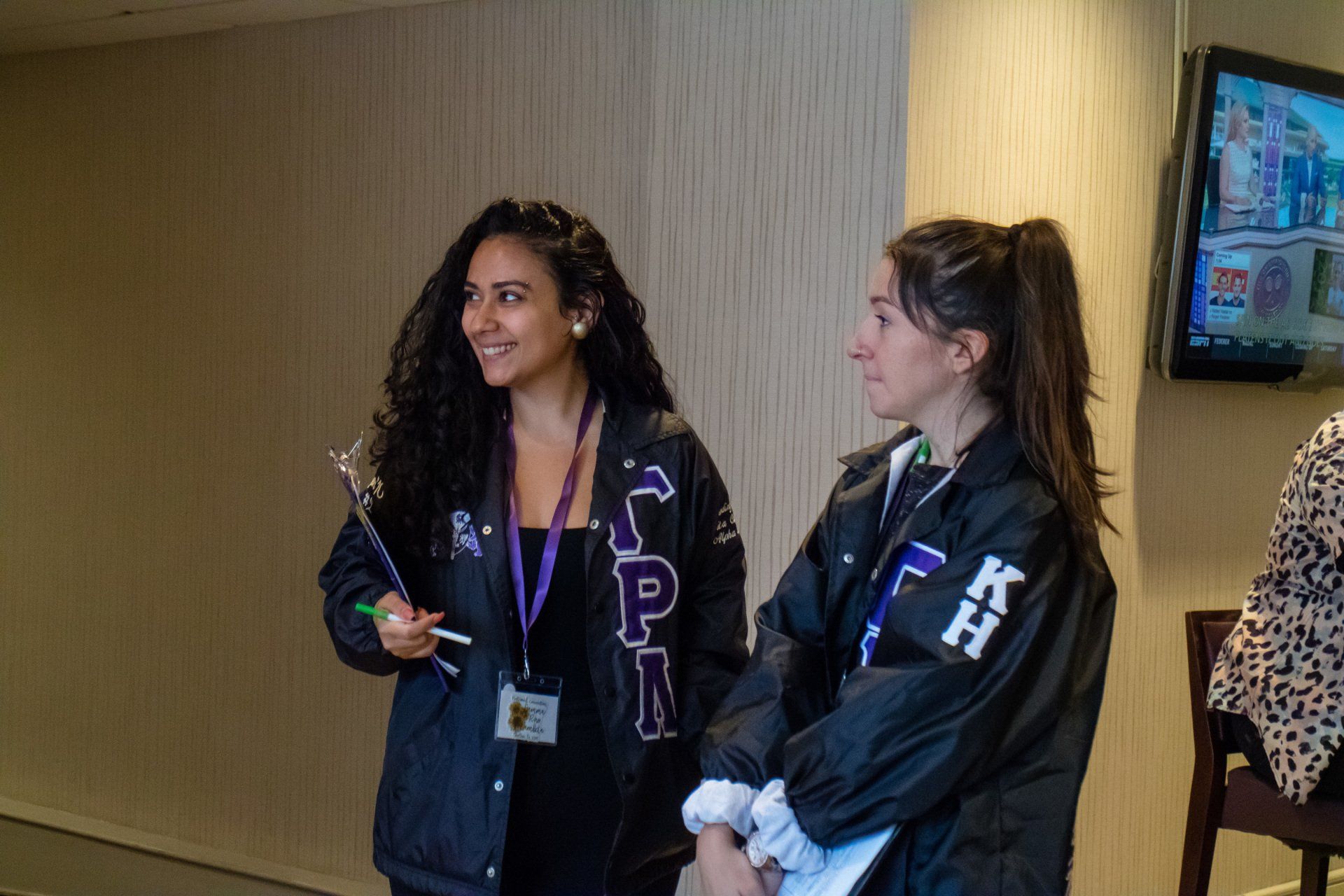 Two people standing together listning to someone off camera