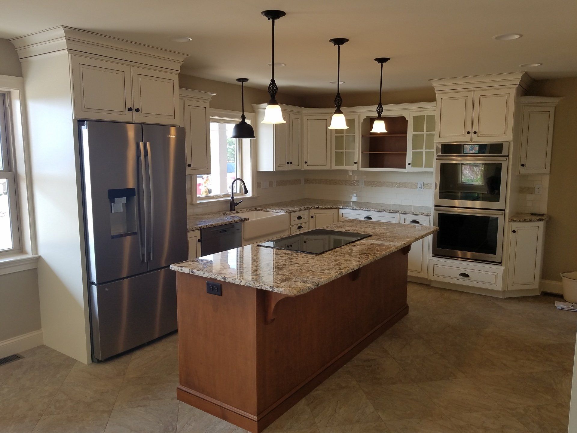 Kitchen with white cabinets, stainless steel appliances, and a wood island.
