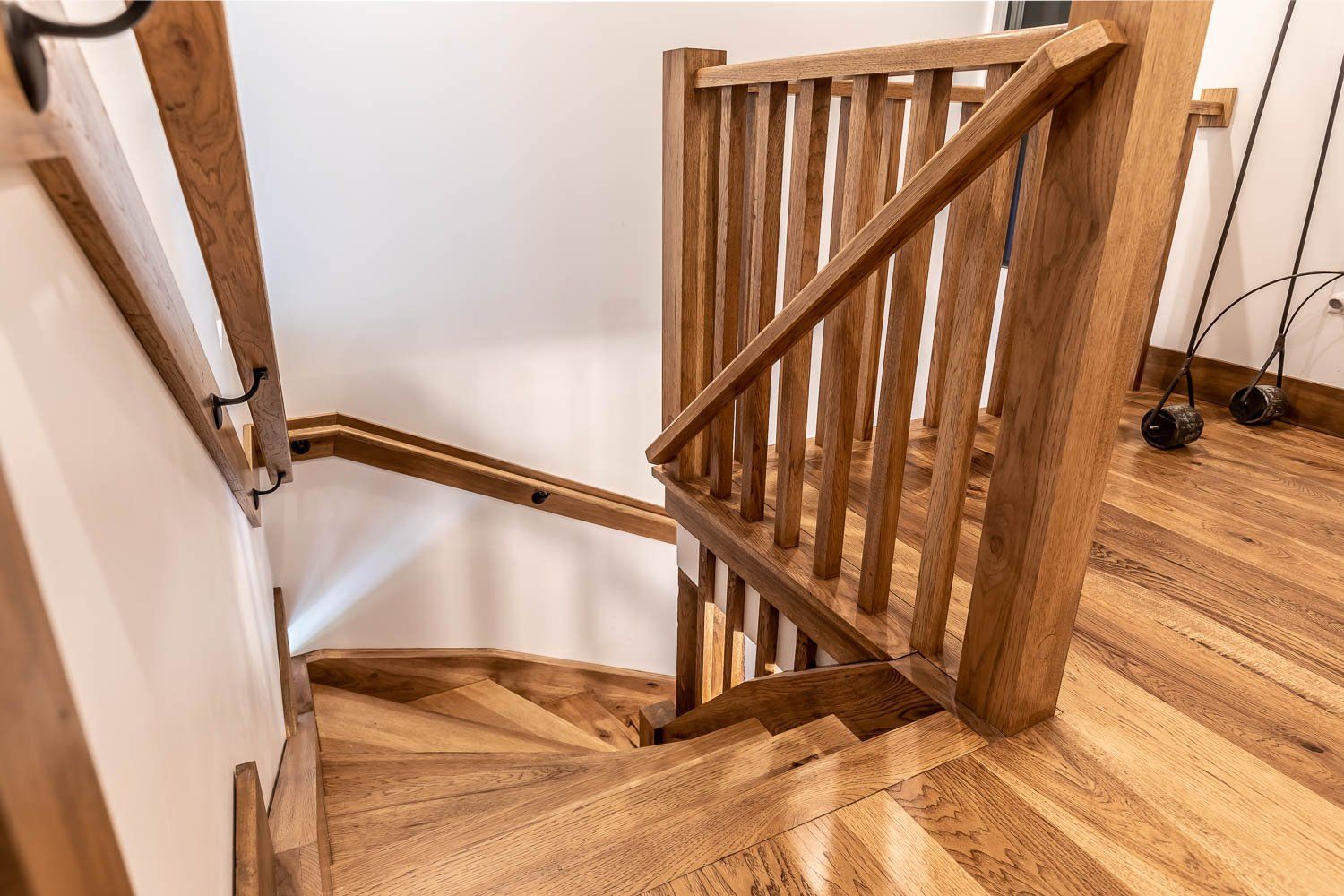 Wooden staircase with railing and banister. Light wood floors and walls.