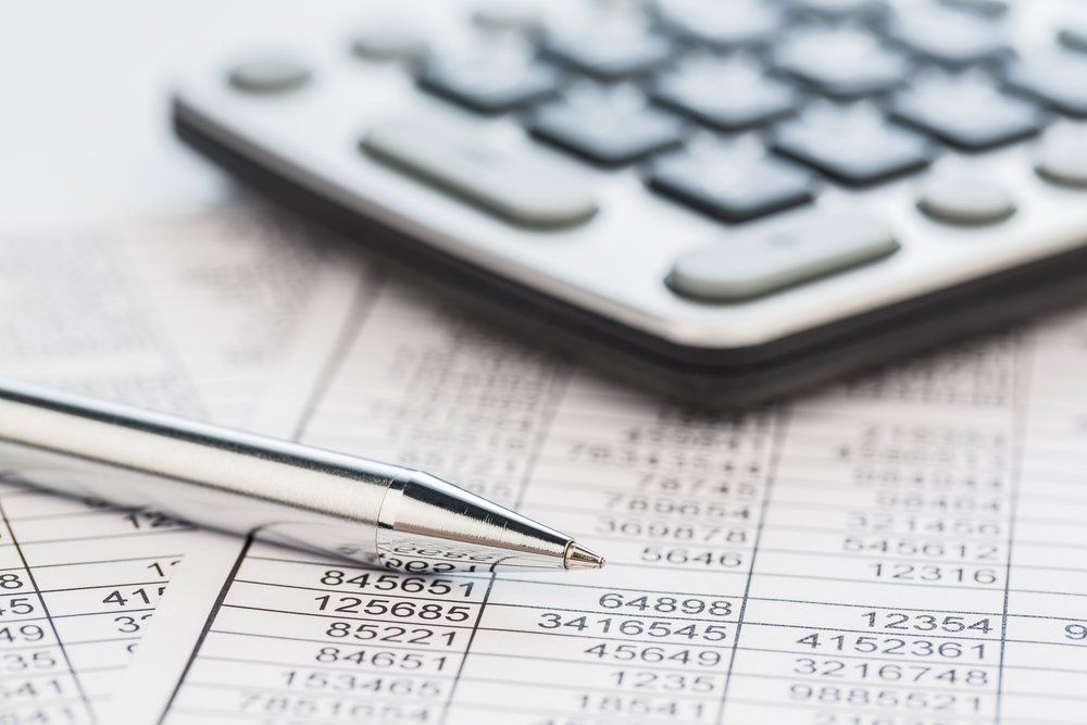 Calculator on balance sheet — Accountants Hervey Bay in Pialba, QLD