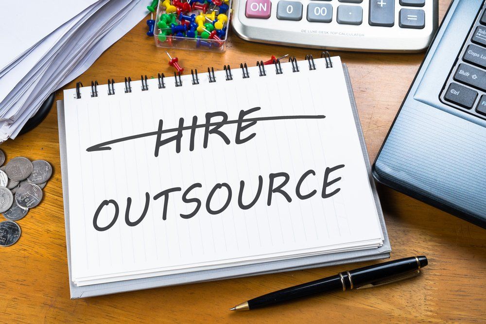 Outsource memo written on a notebook — Fraser Coast Accounting Group in Pialba, QLD