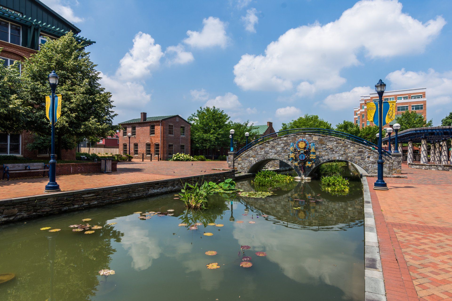 a bridge over a body of water with a clock on it