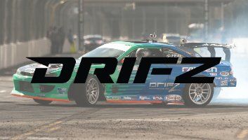 Green and blue car drifting on a racetrack, the word 