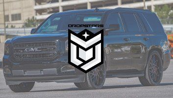 Black GMC Yukon SUV with Dropstars logo in front.