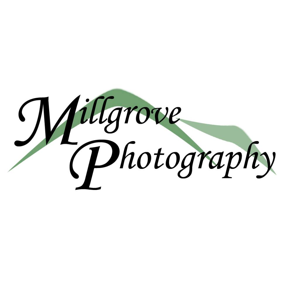 A logo for millgrove photography with a mountain in the background.
