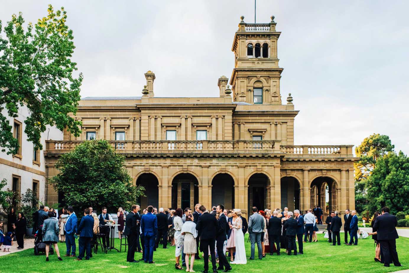 A large group of people are standing in front of a large building.