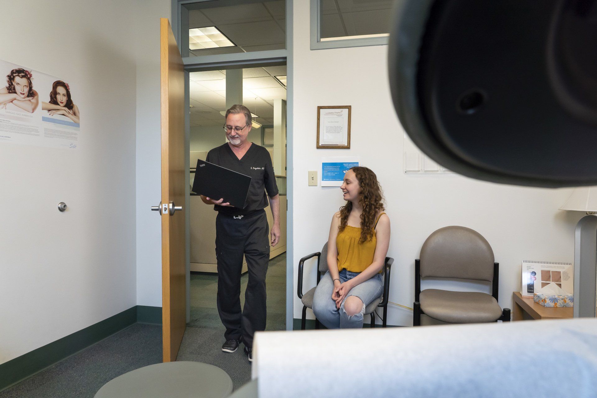 A doctor is talking to a patient in a waiting room