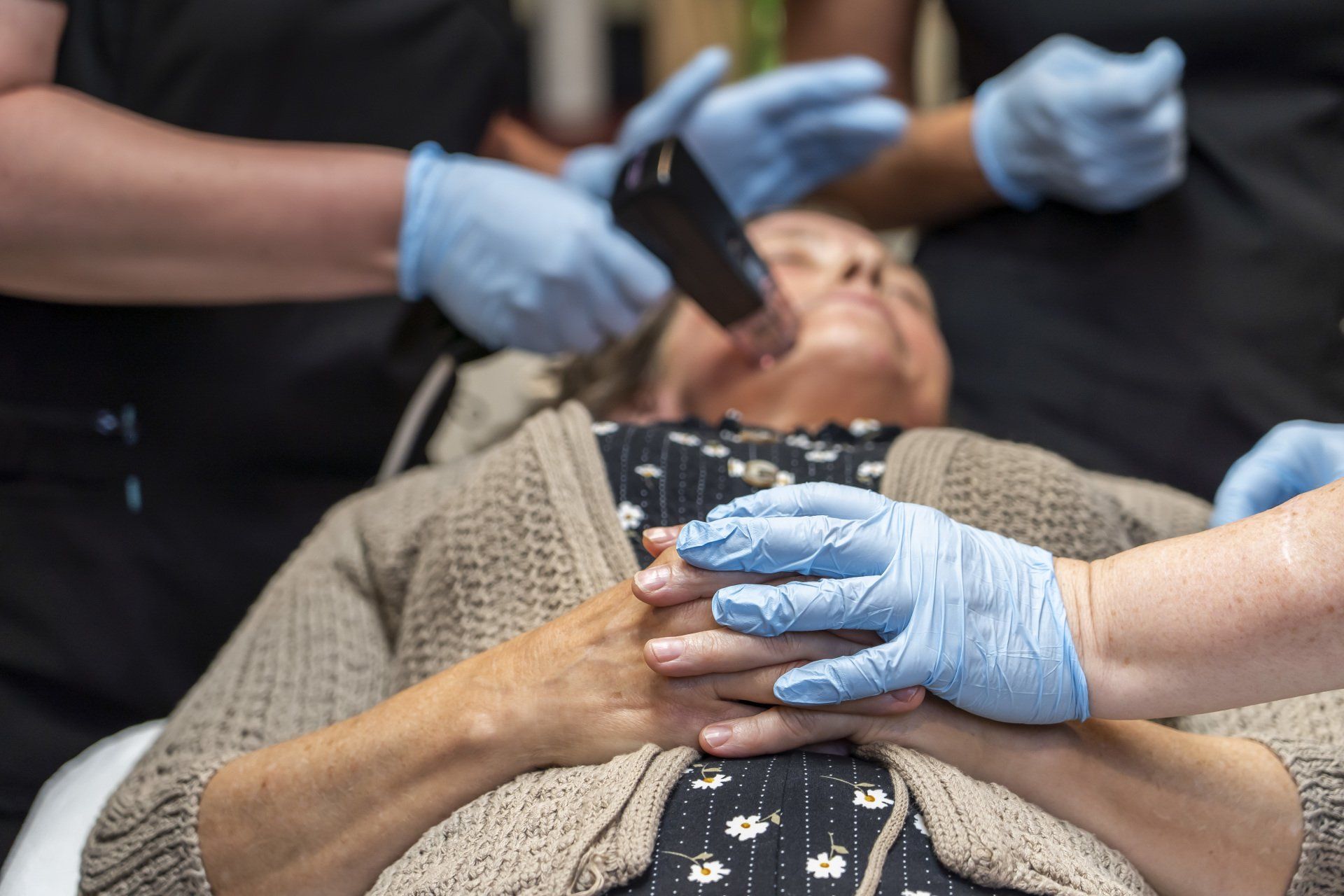 A woman is getting a facial treatment 