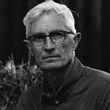 A black and white photo of a man wearing glasses